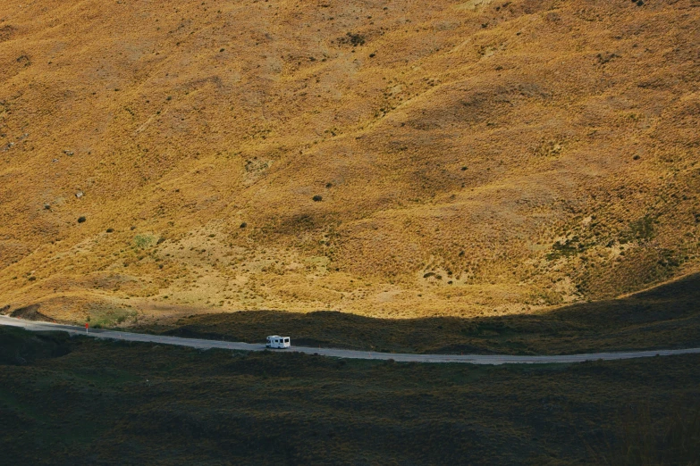 a car driving down a road in the middle of nowhere