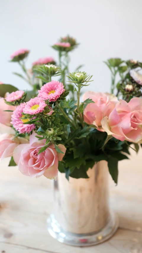 a close - up of a vase of flowers on a table