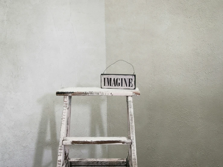 a wooden chair that has been decorated with a small sign