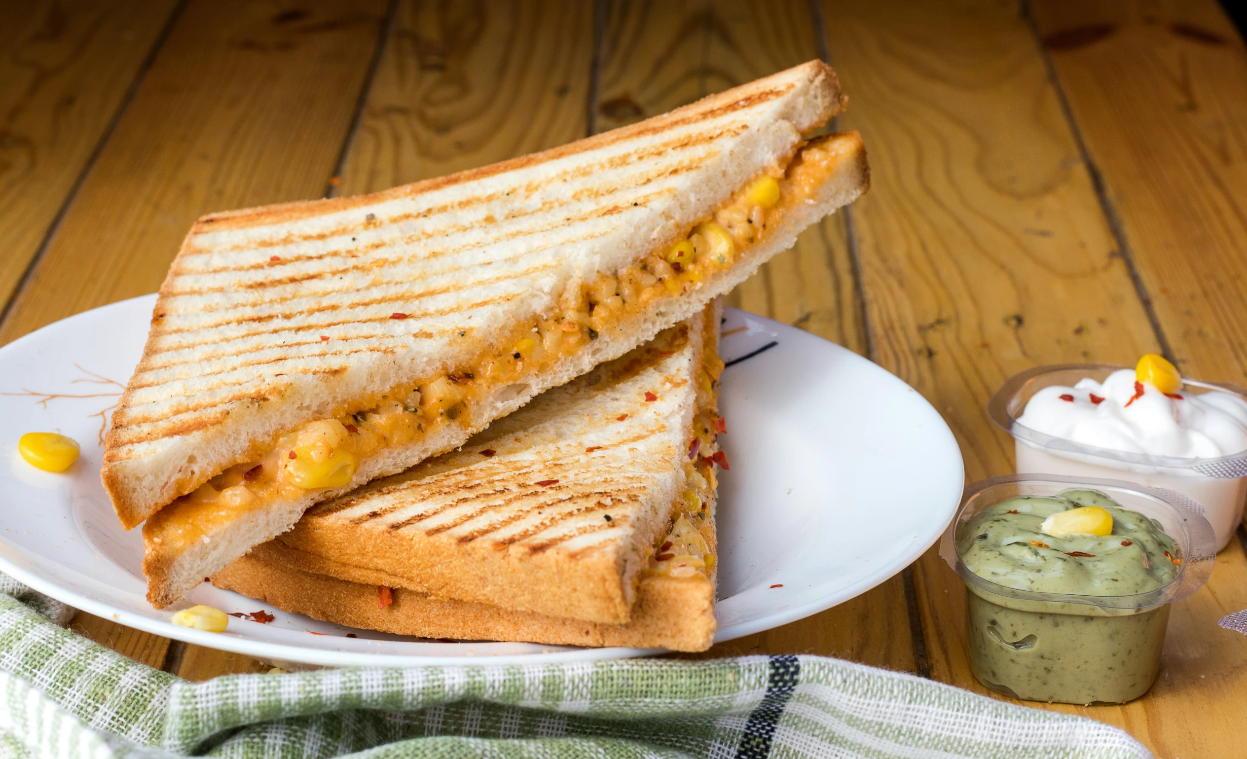 a white plate with two halves of a peanut er and jelly sandwich