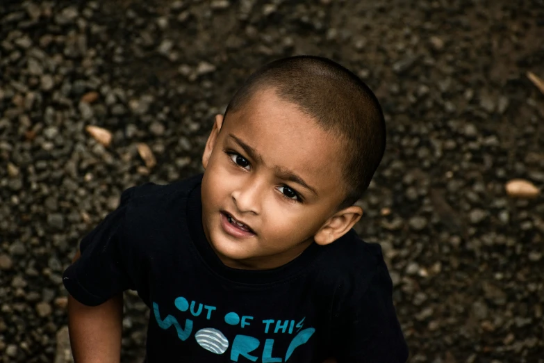 a boy in a black shirt has a cell phone