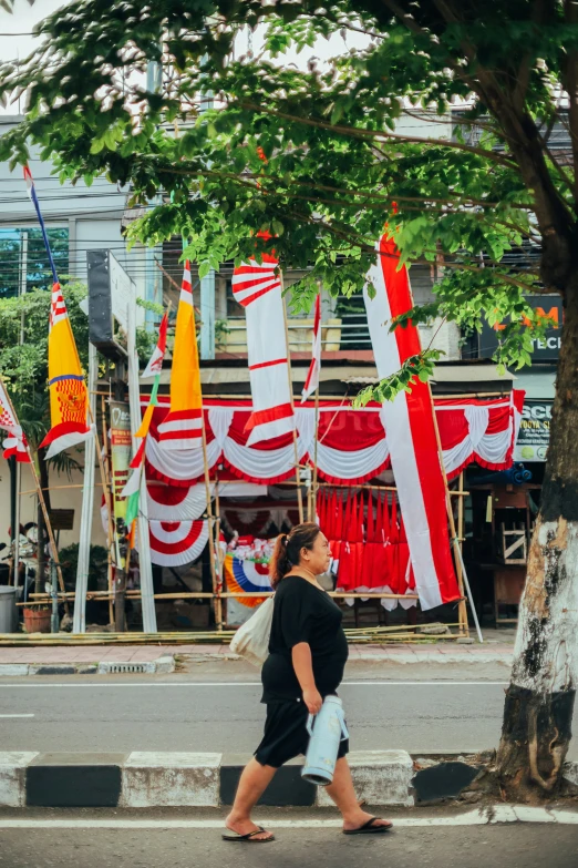 woman walking down the street with flags on her head