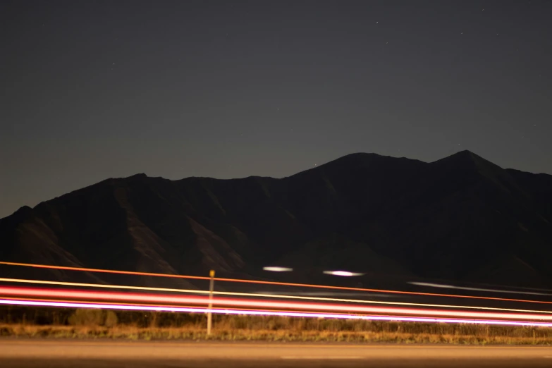 motion blur in a mountain scene with lights in the foreground