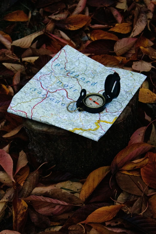 an upside down gps and ear phones on a map