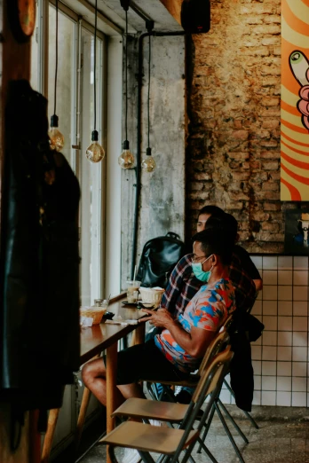 a woman is sitting at a table in the middle of a restaurant