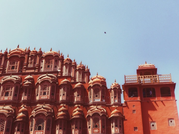 the red building has large windows with balconies on top