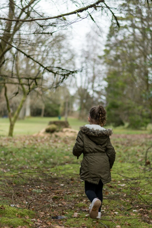 woman walking through a park in the winter