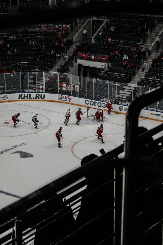 a group of people playing a game of ice hockey