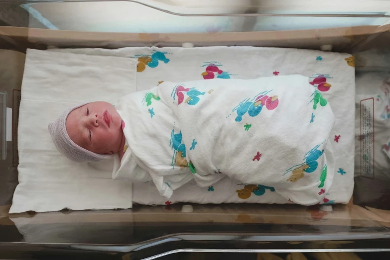 a baby is laying on a white sheet