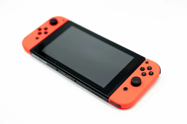 an orange nintendo switch gaming device on a white surface