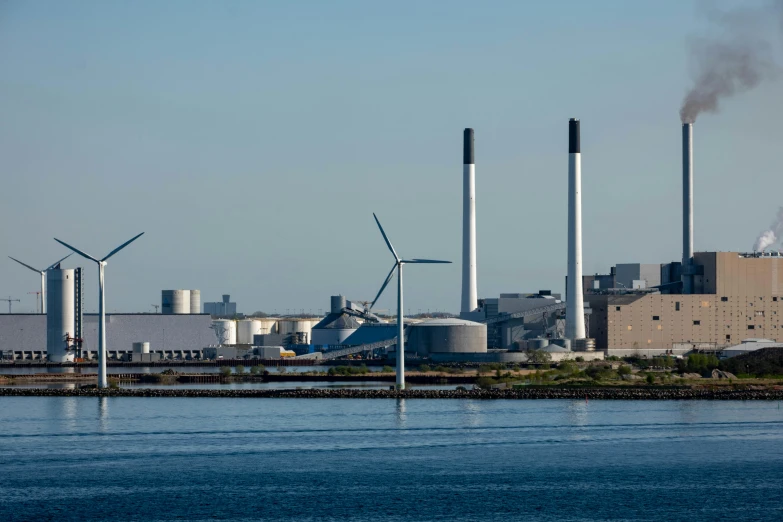 a large industrial area with many factories and wind mills