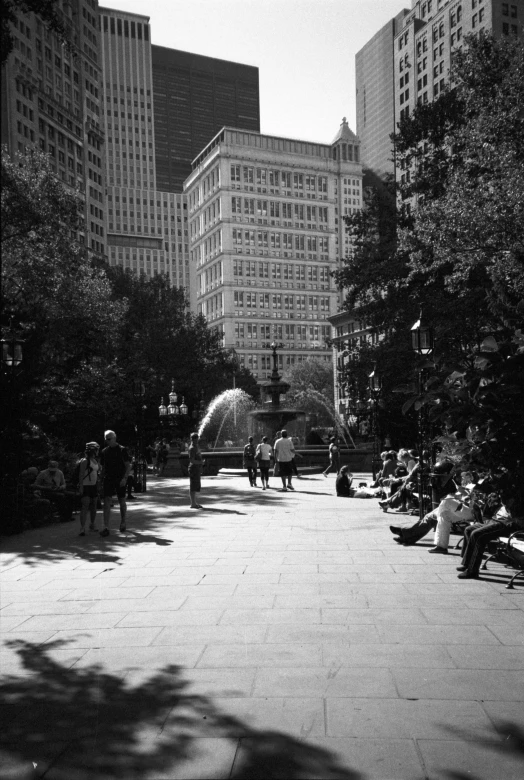 a public square in the city with people sitting and walking