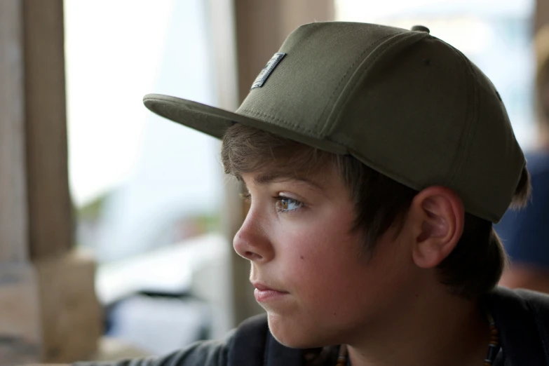 a boy with a hat that says'it is important to be a little boy's hat '