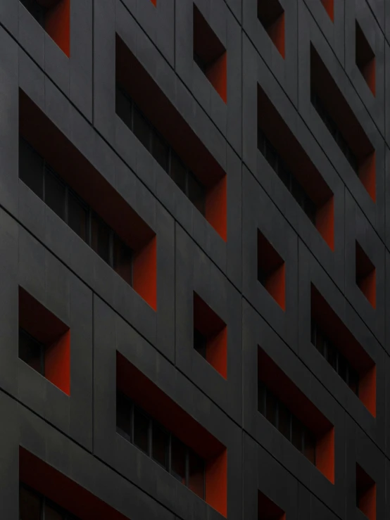 a large building with red window frames on the outside