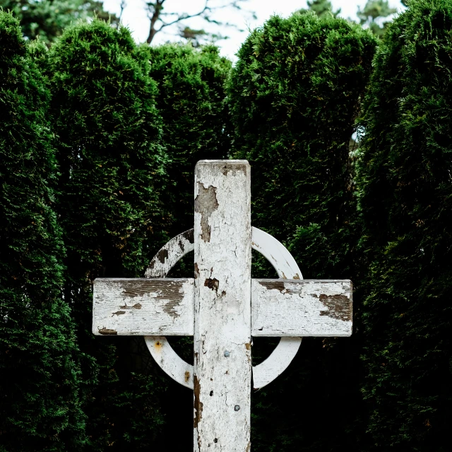 a rustic old wooden cross mounted on the wall