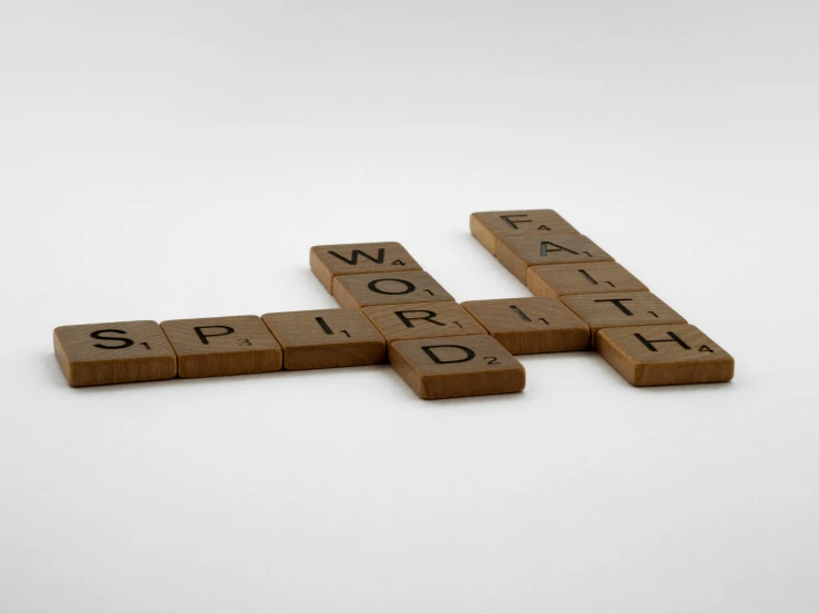 a crossword with words spelled out in wood