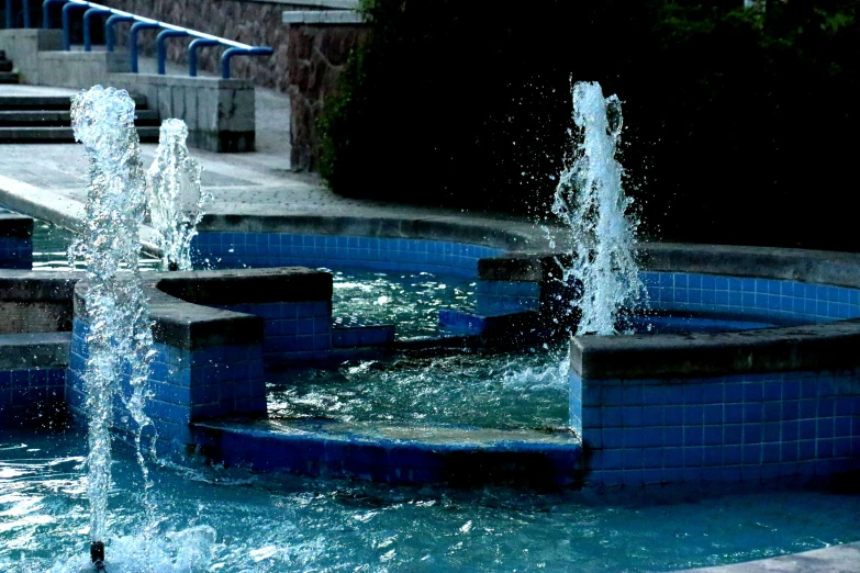 a public fountain with lots of water on it