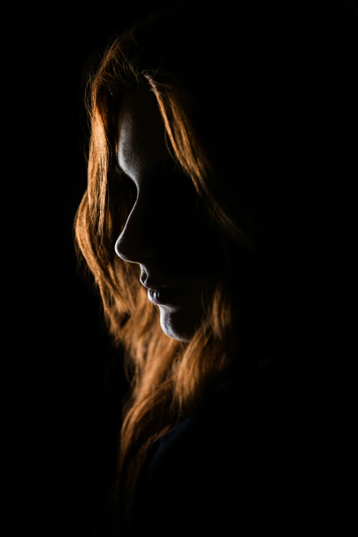 a woman in the dark with long hair