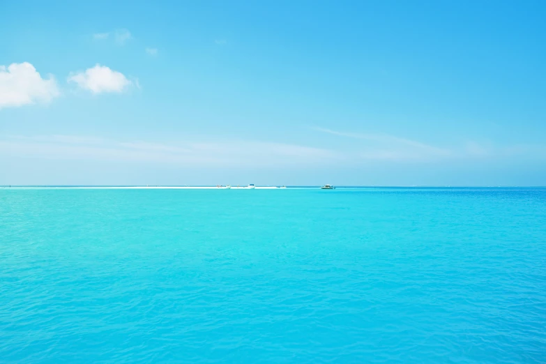 a boat sailing in the distance on water