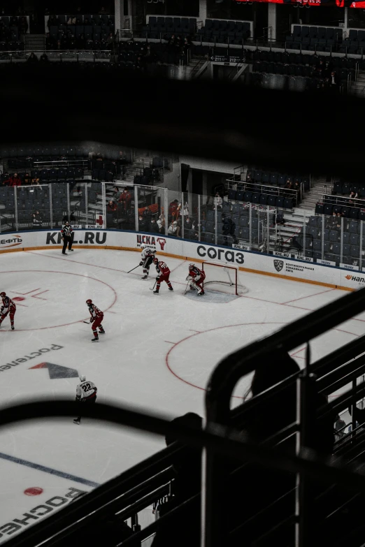 hockey players are playing on a snowy rink