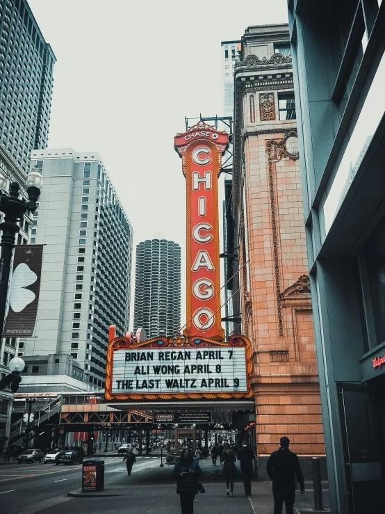 an old theater marquee is on the corner of a street