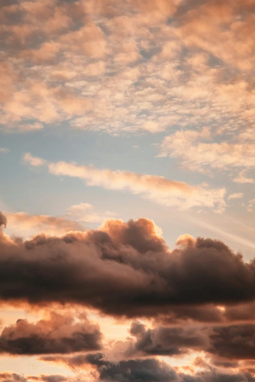 an airplane is flying in the sky at sunset