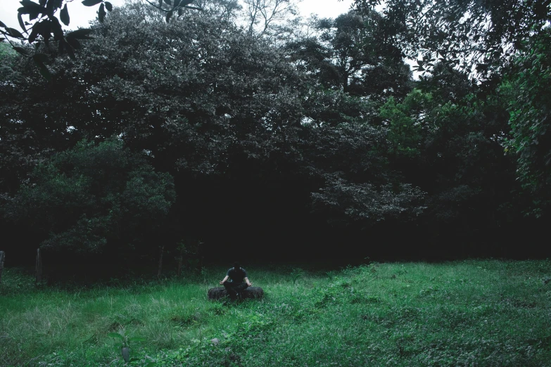 a person that is laying down on a grass hill