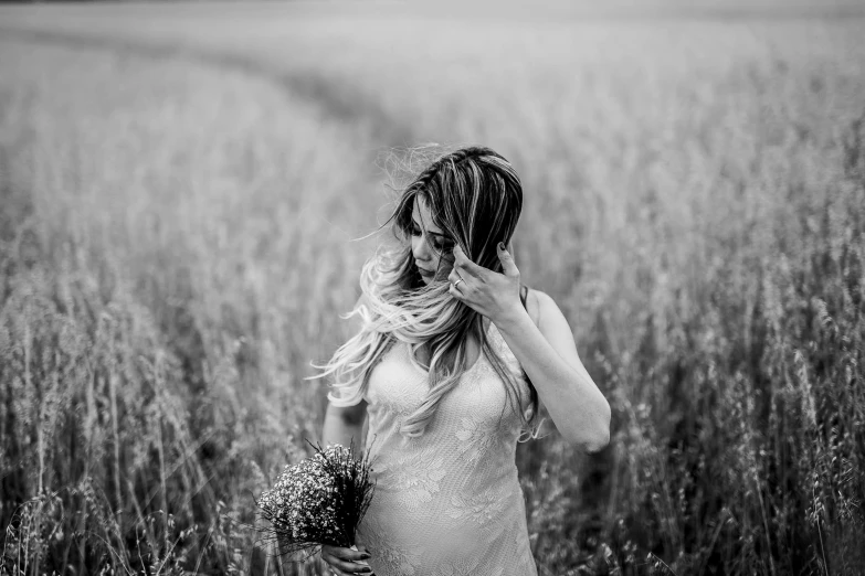 the back of a woman's head in an empty field