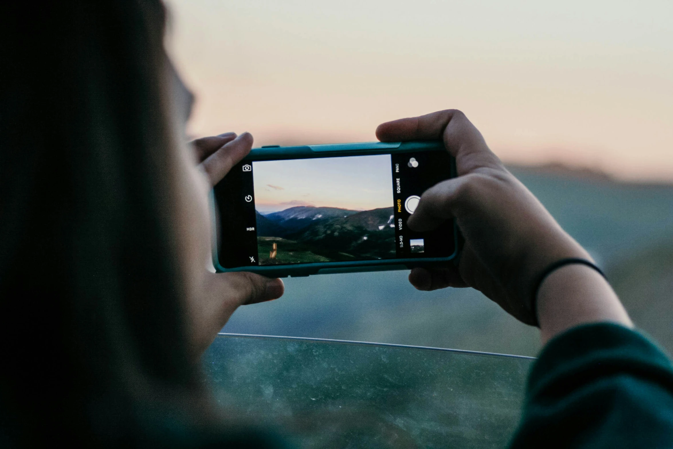 a person holding a camera and taking pictures