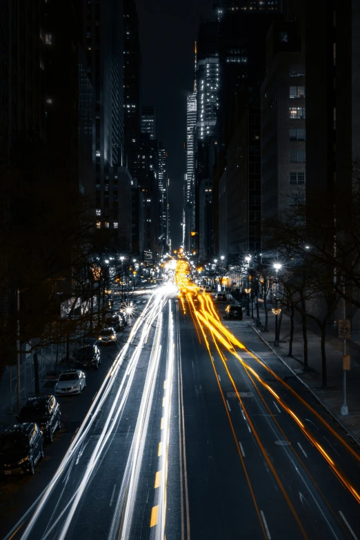 light trails are shown on an empty city street at night