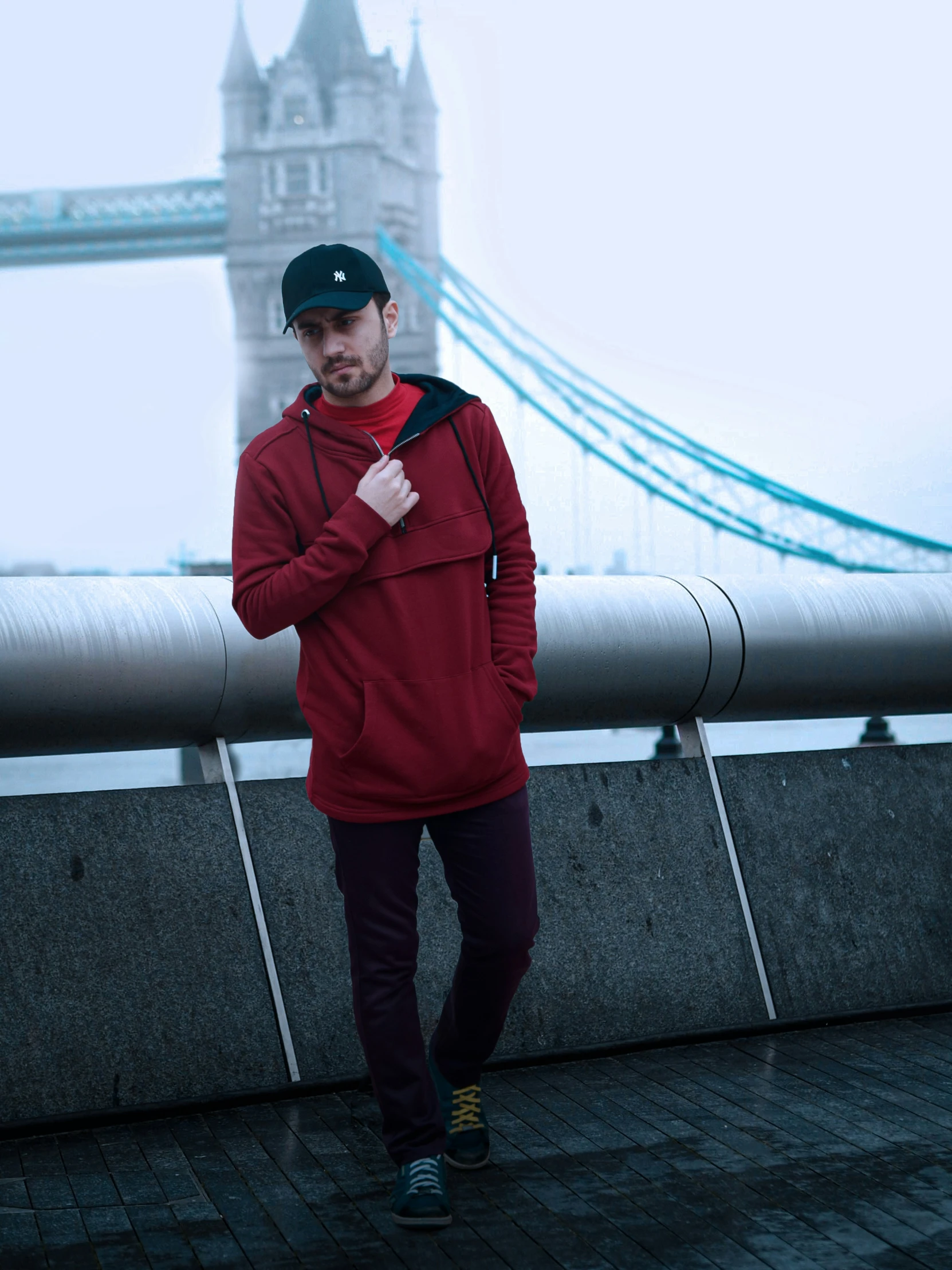 a man in red hoodie standing by the water