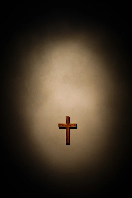 an image of a wooden cross in a dark background