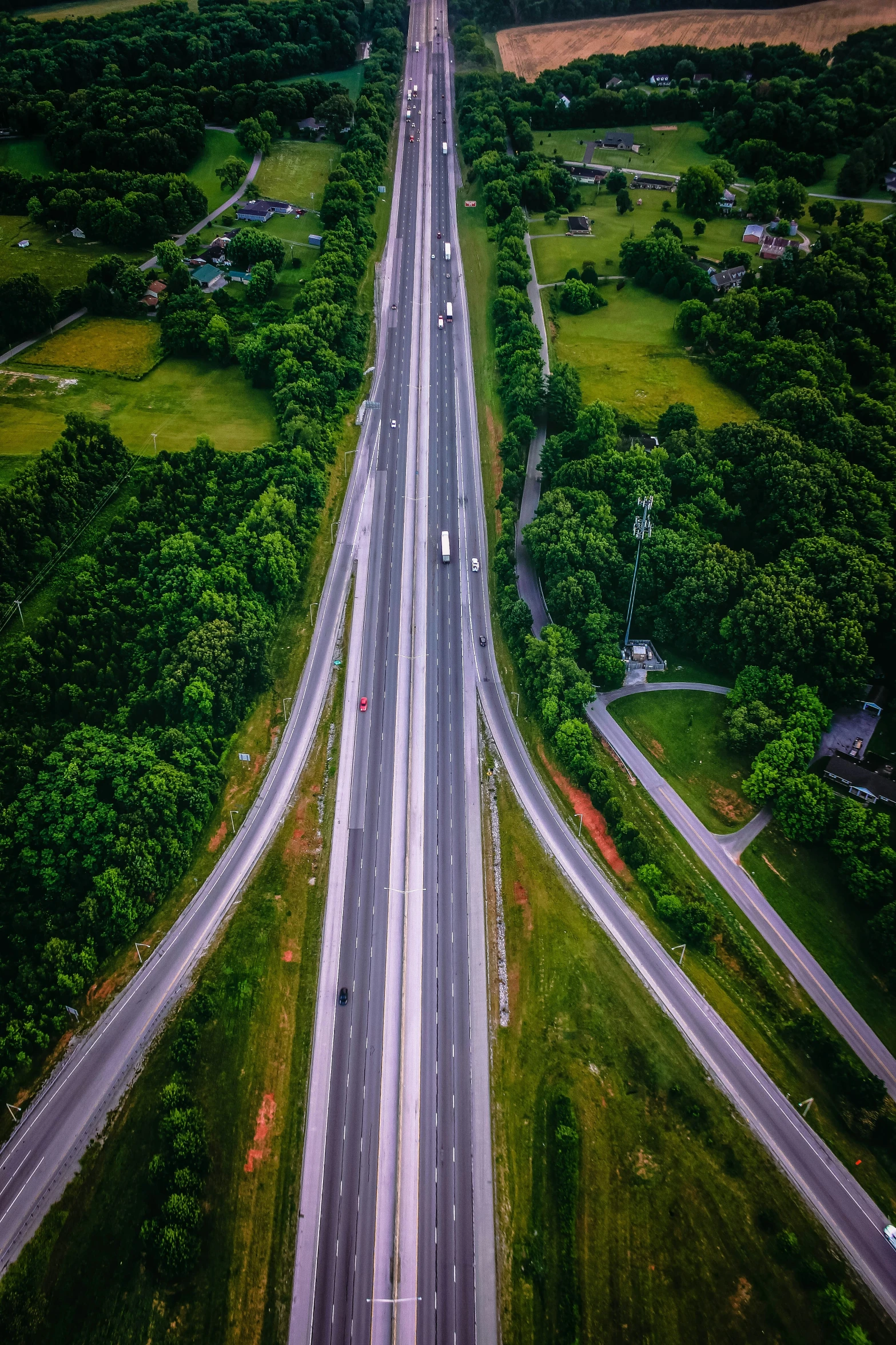 a long empty highway in the country, with trees