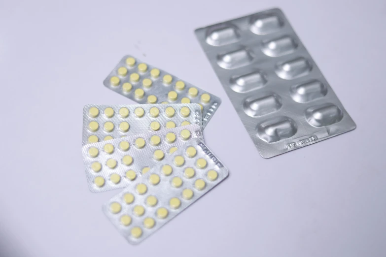 closeup image of contramy pills and contraption on white table