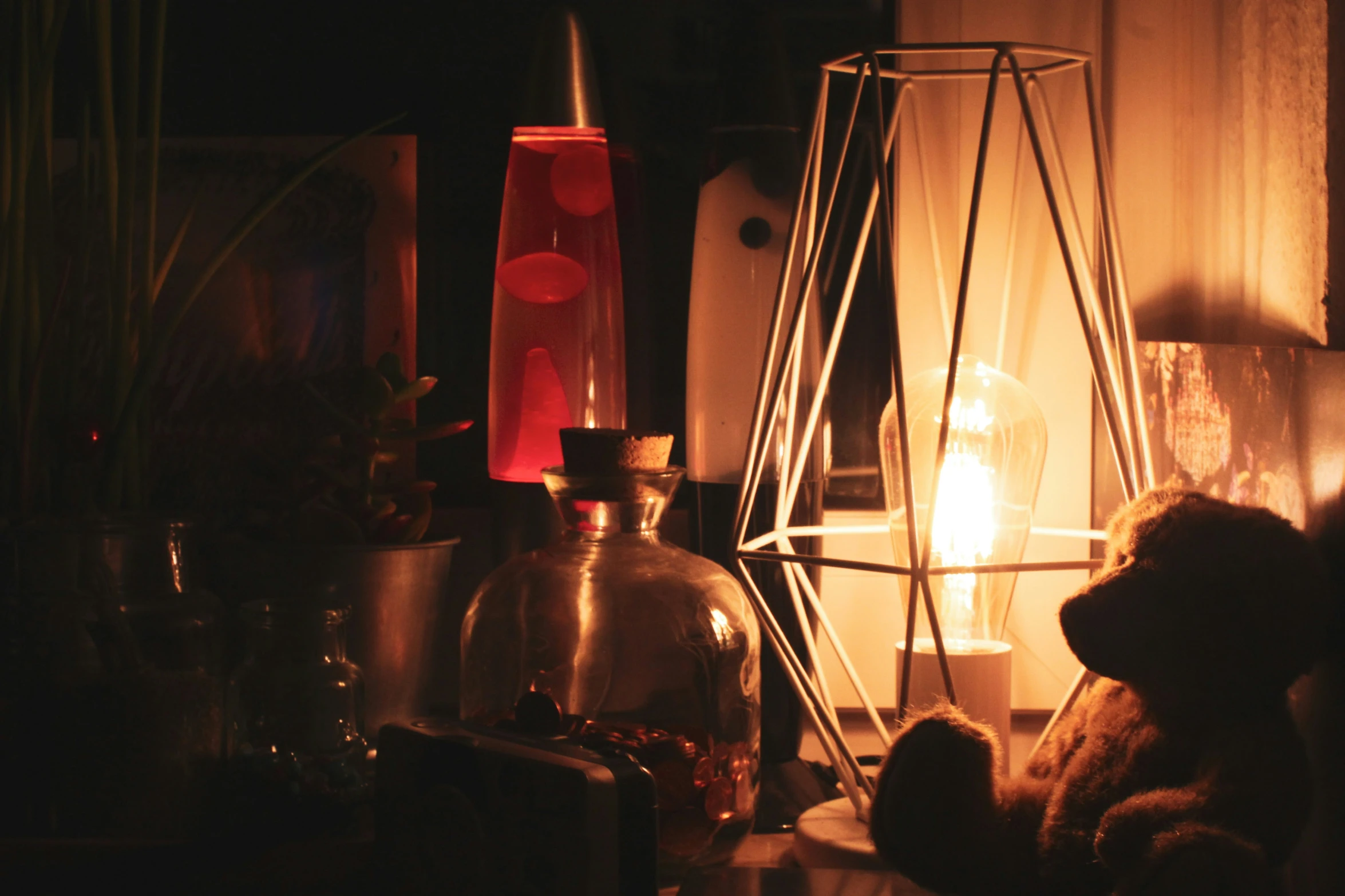 a candle that is next to a clear glass vase