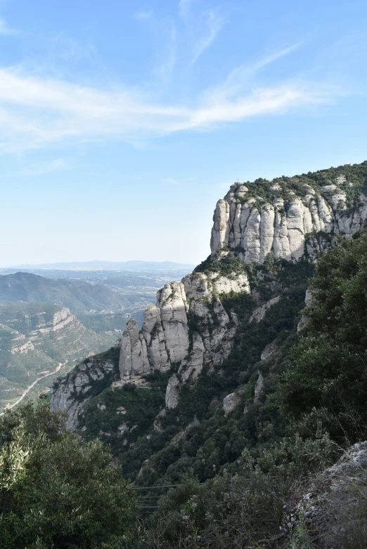 view of a mountain with lots of green bushes