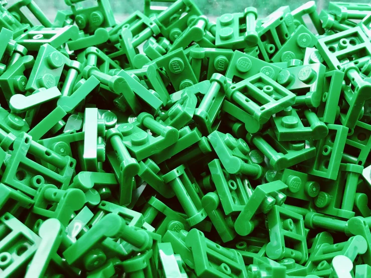 closeup of green lego bricks are piled high