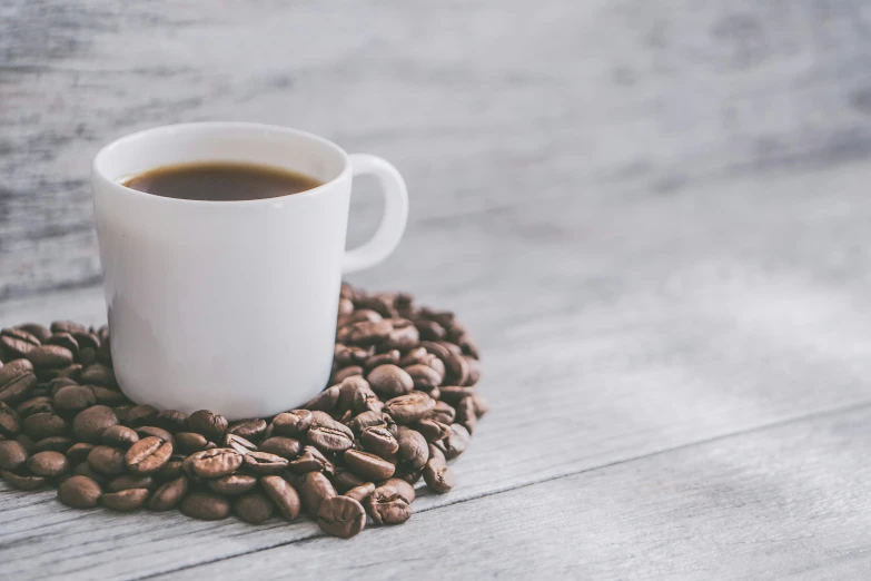 a coffee cup with espresso on top of it