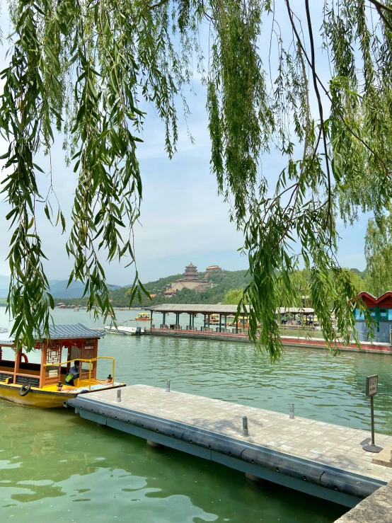 a barge in the water near some trees and a pier