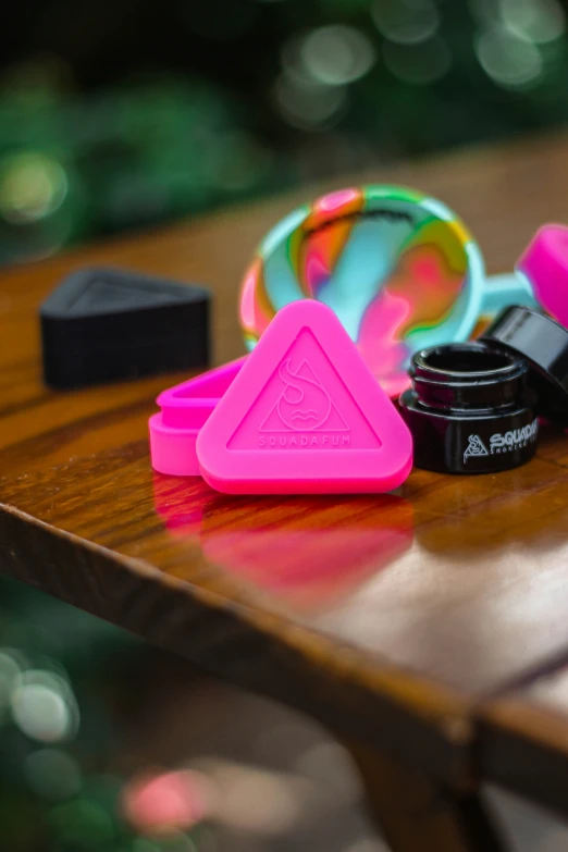 colorful items on a table including ring, celet, and lipstick