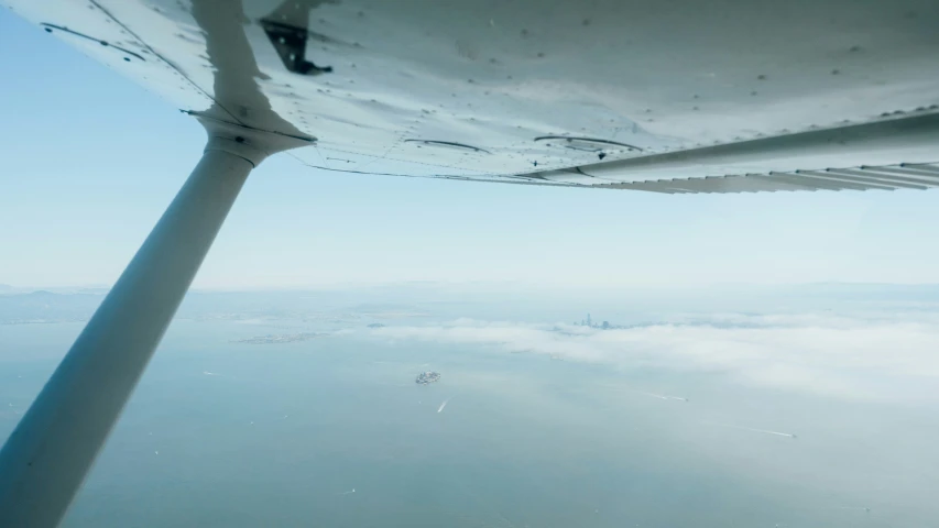 a view from an airplane window of a foggy sky