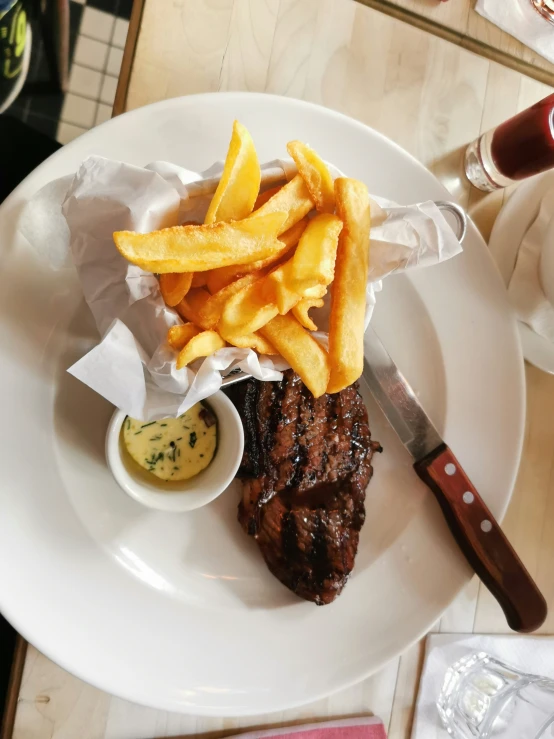 a plate with fries, fries and steak on it