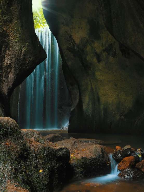 a small waterfall runs into a pool of water