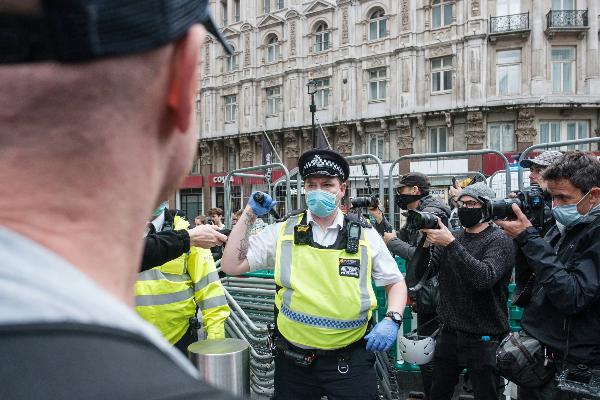 people in safety gear gathered around on a city street