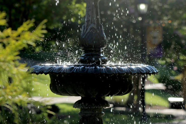 a black water fountain sprinkled with rain