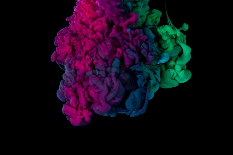 a colorful colored substance flying in the dark
