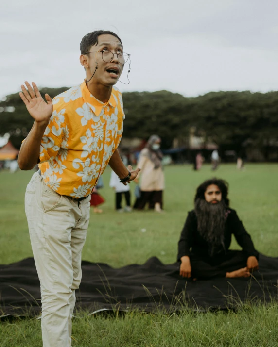 man performing a trick while standing in the field with others