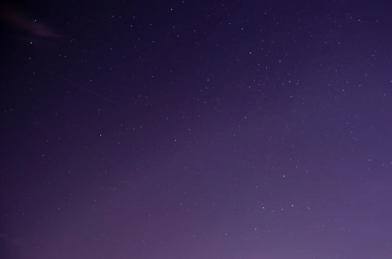 a silhouette against the night sky at the moon