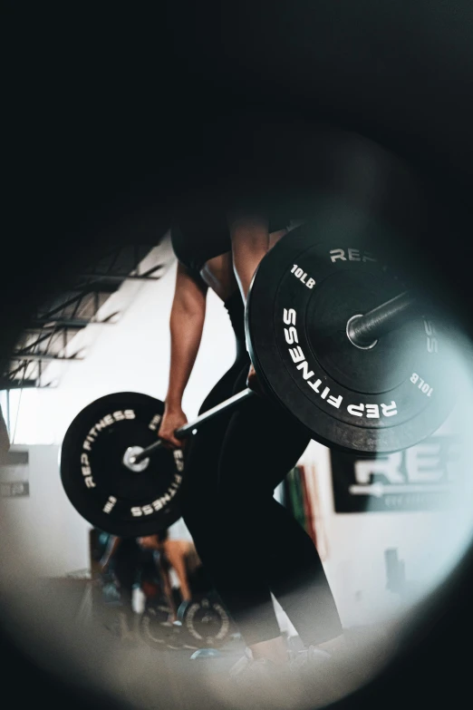 a man lifting a disc in the gym