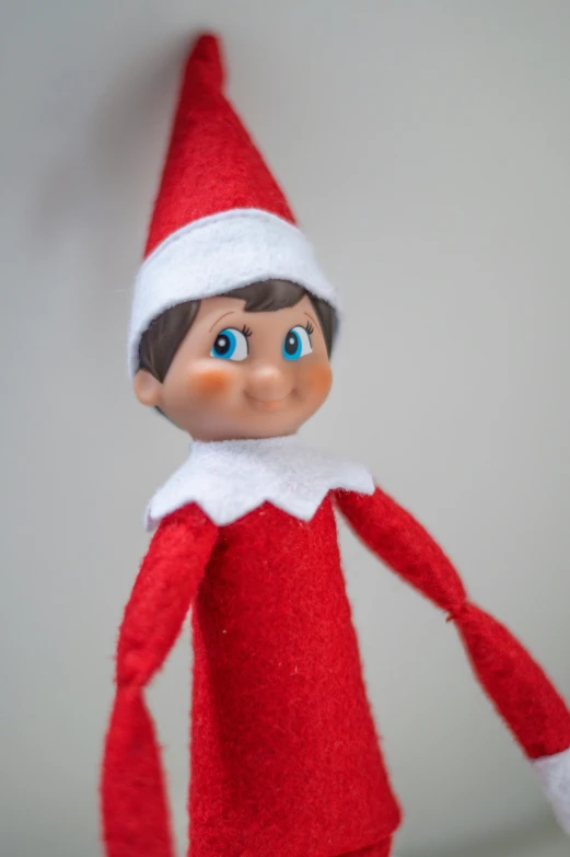 a christmas elf toy laying on top of a shelf